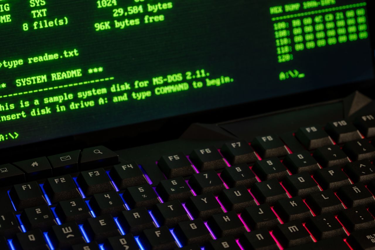 Crafting Captivating Headlines: Your awesome post title goes here Close-up of a retro computer screen displaying MS-DOS commands with a vibrant keyboard.