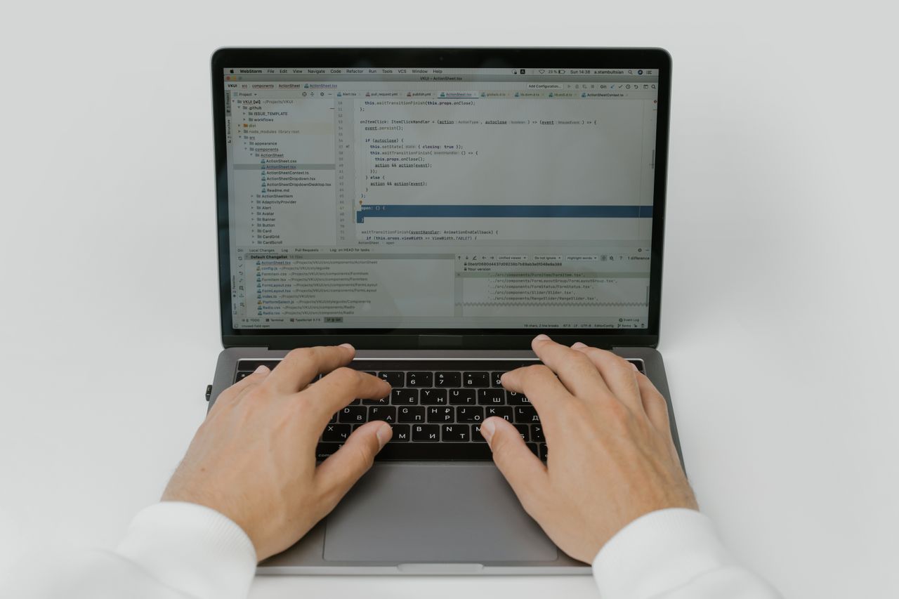The Art of Drawing Readers In: Your attractive post title goes here Close-up of hands coding on a laptop, showcasing software development in action.